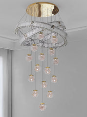Modern chandelier with glass bulbs and gold accents hanging from the ceiling.