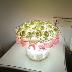 Decorative lamp with floral design on a white surface