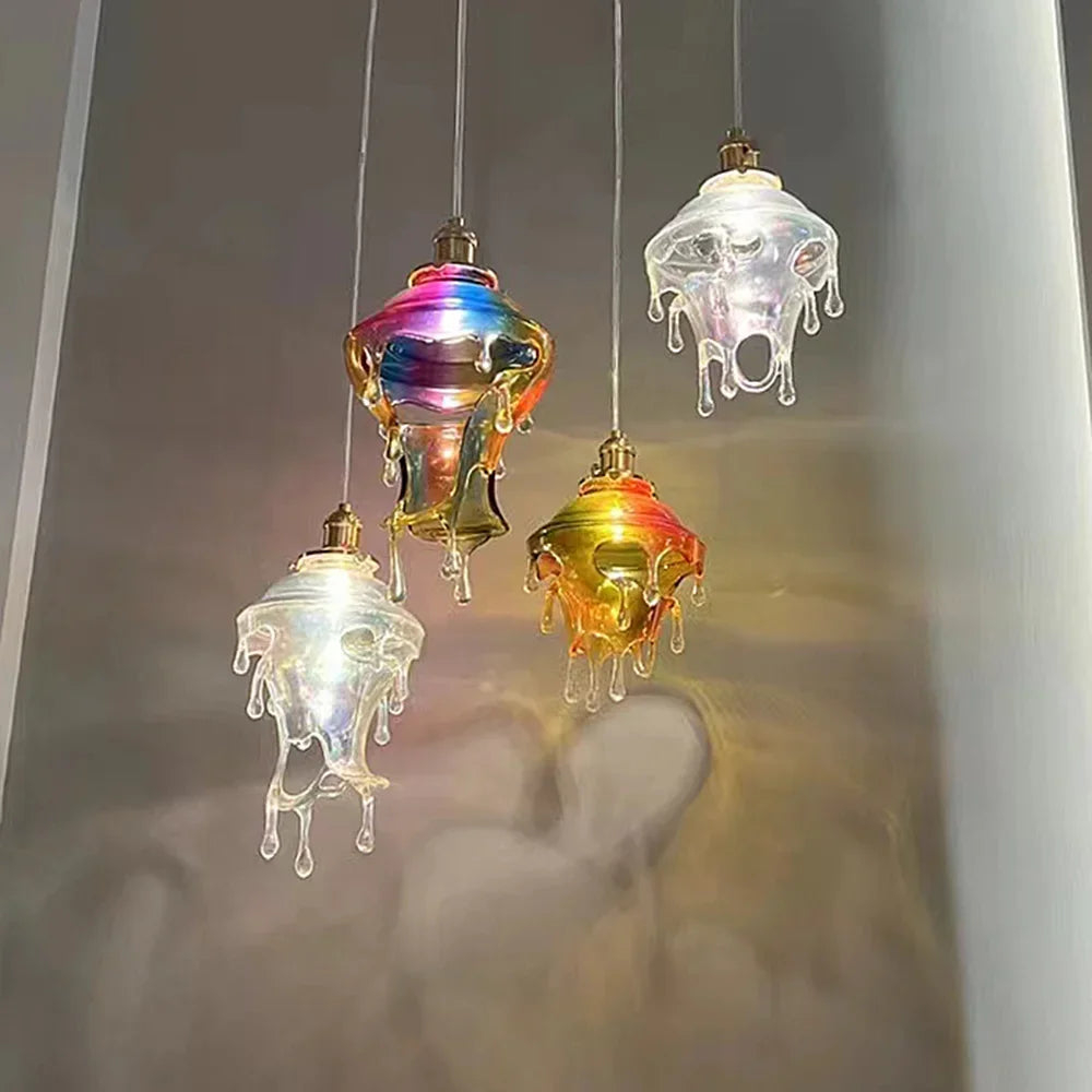 Colorful glass pendant lights hanging against a neutral background