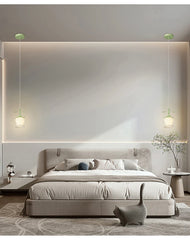 Two flower-shaped pendant lights hanging on either side of a bed in a modern bedroom, with subtle backlighting.