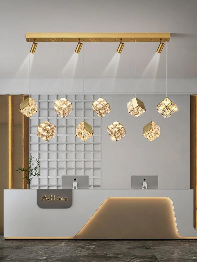 Modern interior design with gold ceiling lights and a reception desk.