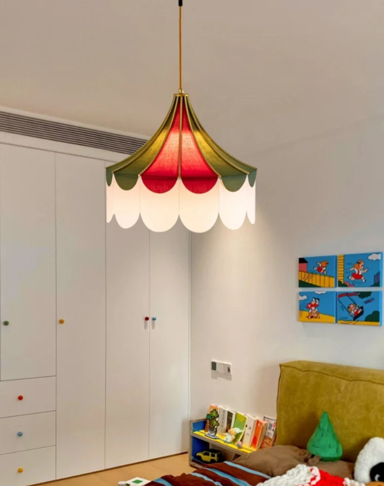 Colorful pendant light in a room with a white wardrobe and children's artwork on the wall.