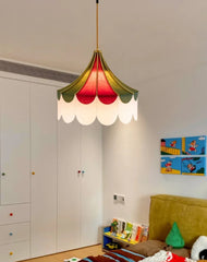 Colorful pendant light in a room with a white wardrobe and children's artwork on the wall.
