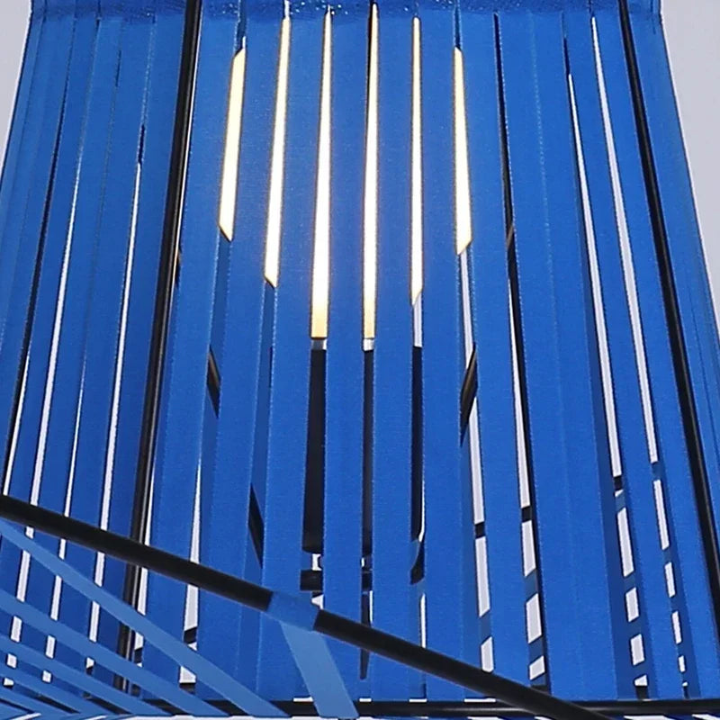 Blue metal slat fence with a clear sky background