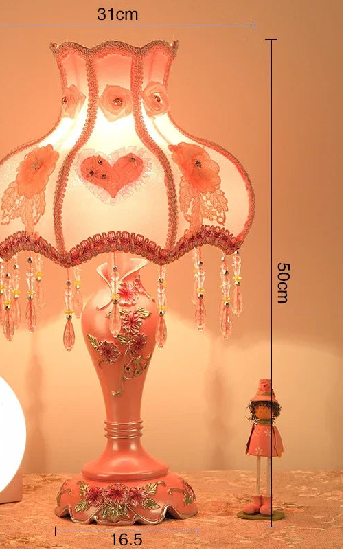 Decorative table lamp with floral design and measurements on a neutral background