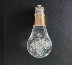 Decorative light bulb with water droplets on a dark background