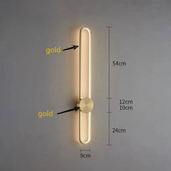 Gold wall light fixture with dimensions on a gray background