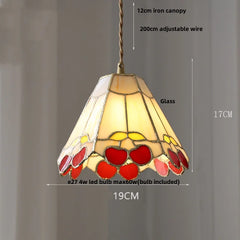 Stained glass pendant light with decorative design on a gray background