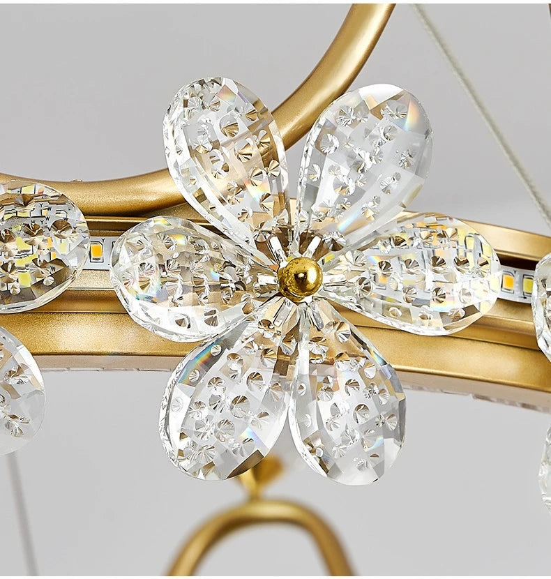 Close-up of a decorative item with crystal flower design on a gold frame.