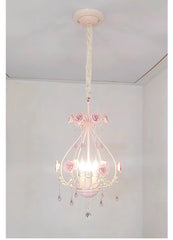 Close-up view of the pink crystal chandelier with rose details and hanging prisms.