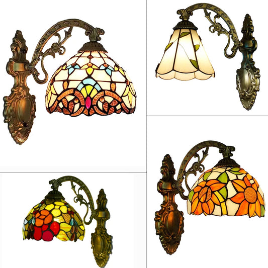 Collage of four Tiffany style wall sconces with stained glass shades in various floral and geometric patterns, mounted on ornate metal arms.