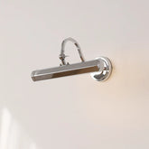 Chrome wall-mounted light fixture on a neutral background