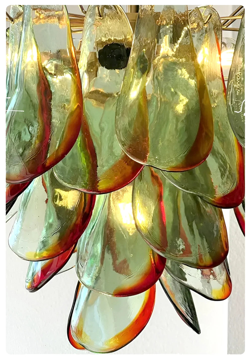 Decorative chandelier with colorful glass shades on a white background