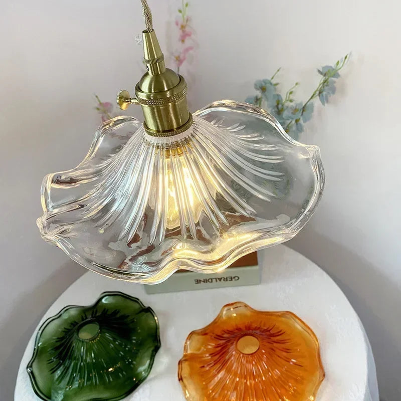 Decorative lamp with shell design on a white surface with floral background
