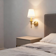 Bedroom with a nightstand and wall lamp on a gray wall