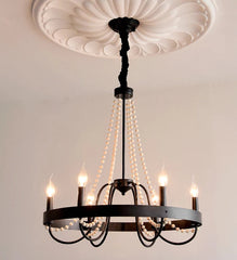 Black chandelier with six lights on a plain background