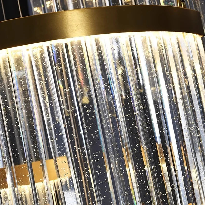 Close-up view of the clear crystal rods with internal bubbles on the gold tiered crystal waterfall chandelier, showing the reflective quality of the crystals.