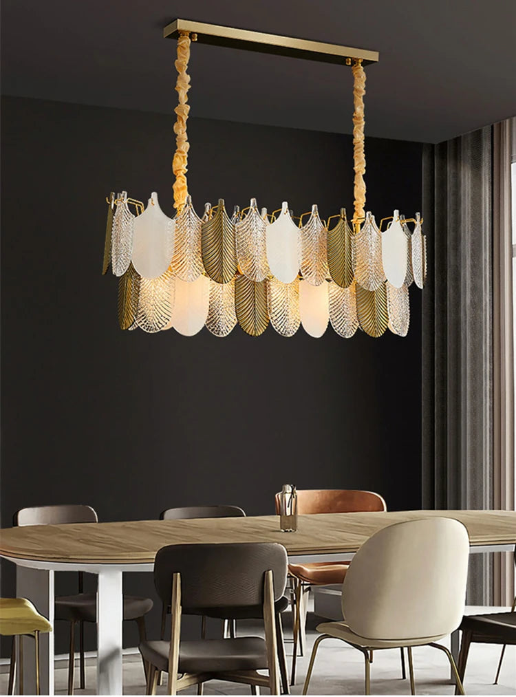 Modern chandelier hanging above a dining table with chairs in a room.