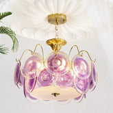 Gold semi-flush mount chandelier with iridescent purple glass discs