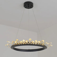 Modern chandelier with black frame and gold accents on a gray background