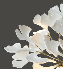 Decorative white floral arrangement with gold accents on a dark background