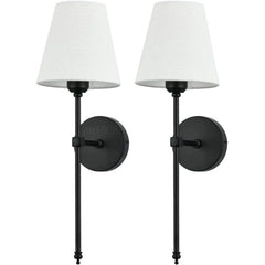 Two matte black wall sconces with white fabric shades against a white background.