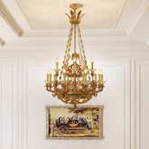 Gold candelabra crystal chandelier with flying eagle details hanging in a white room with a painting below.