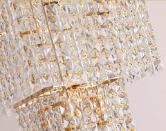 Close-up of a crystal chandelier with gold accents on a light background