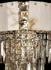 Luxurious crystal chandelier with marble accents on a black background