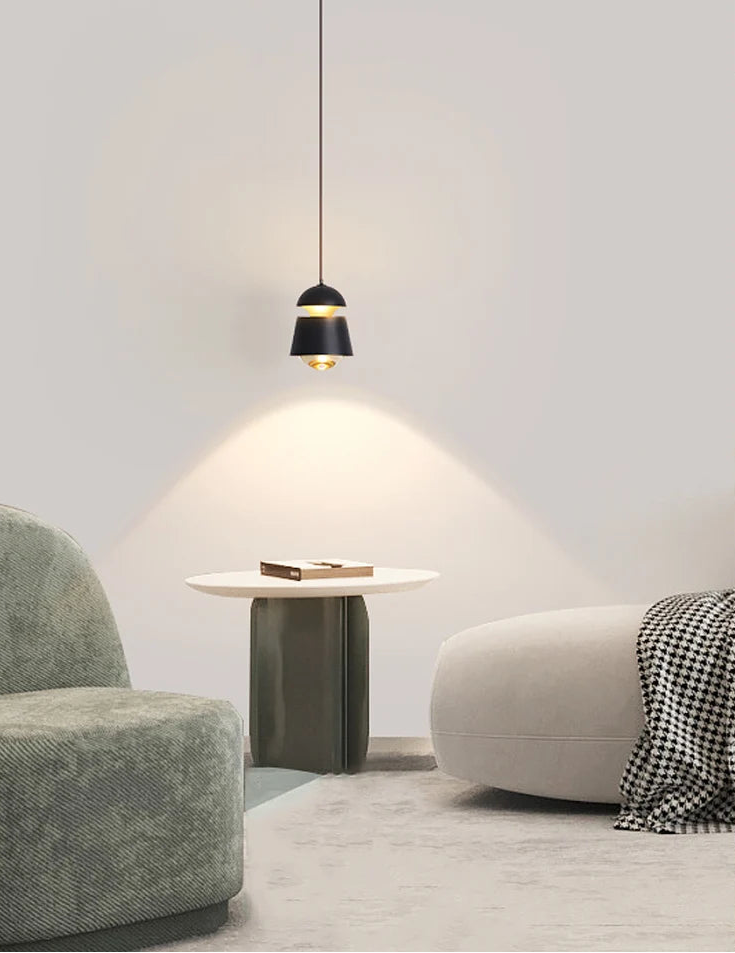 Modern interior with a pendant light, side table, and two chairs.