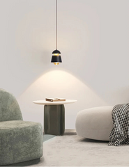 Modern interior with a pendant light, side table, and two chairs.