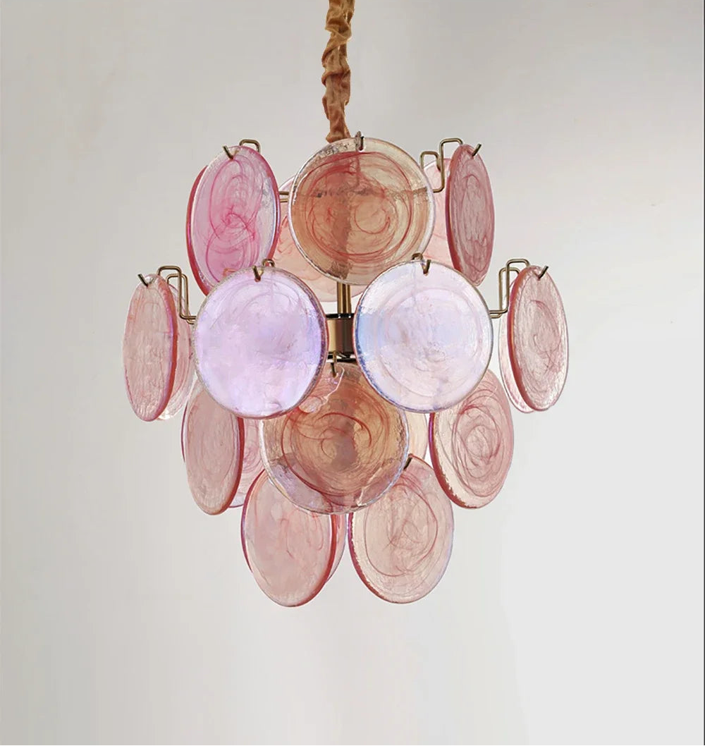 Pink glass disc chandelier on a plain background