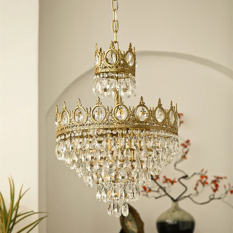 Ornate chandelier with crystal accents hanging against a neutral background