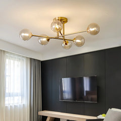 Gold sputnik starburst semi-flush ceiling light installed in a room with a dark accent wall and television