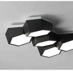 Modern ceiling light fixture with geometric design on a gray background