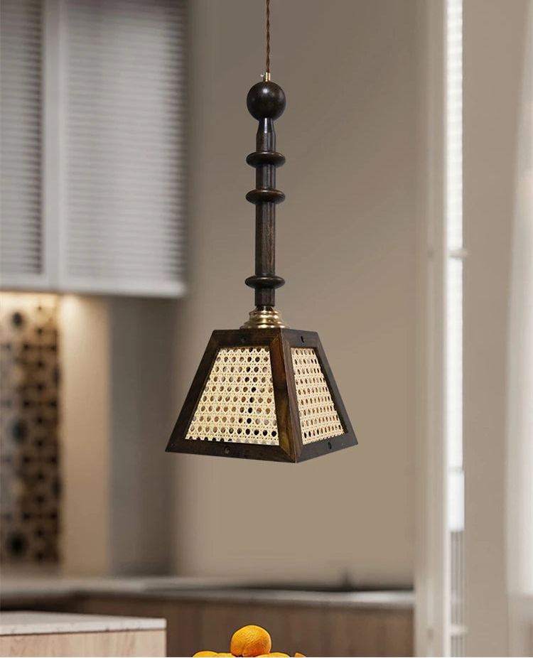 Decorative pendant light hanging in a room with neutral walls and a window.