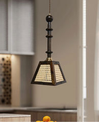 Decorative pendant light hanging in a room with neutral walls and a window.