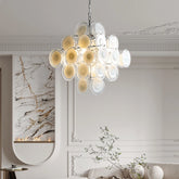 A modern chandelier with multiple white and yellow glass petals cascading downwards, mounted on a chain from a white ceiling.
