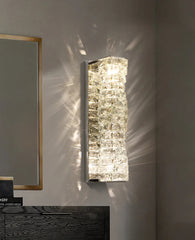 Decorative wall mirror with textured glass panel on a neutral wall.