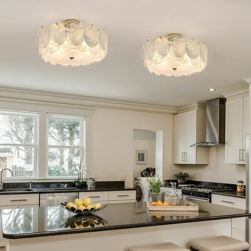 Two white glass floral flush mount ceiling lights installed in a modern kitchen.