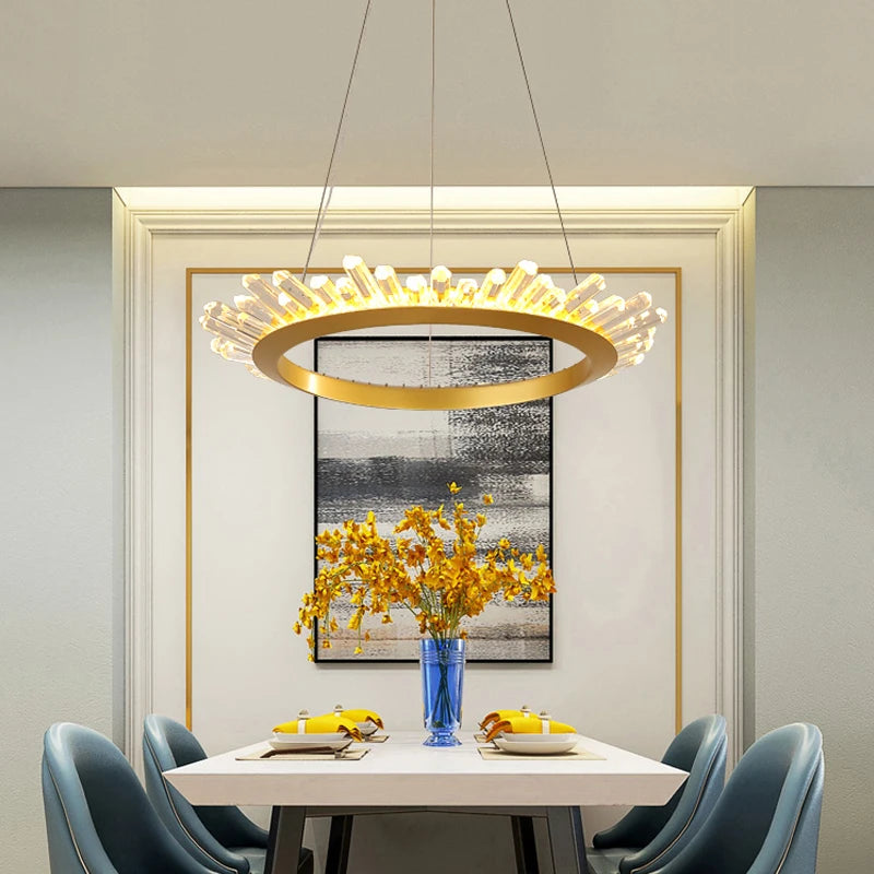 Modern dining room with a chandelier, table, chairs, and decorative elements.