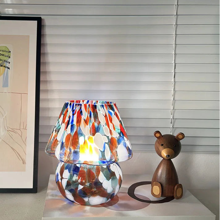 Colorful lamp and wooden bear figurine on a shelf with a blurred background