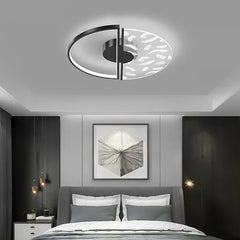 Modern bedroom with a ceiling light fixture, bed, and wall art.