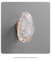 Decorative door handle with a textured design on a gray background