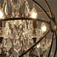 Close-up of a chandelier with crystal elements and warm lighting.