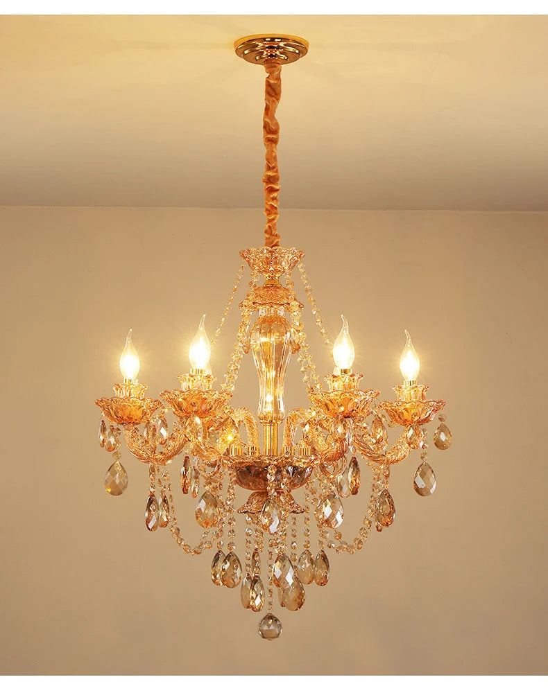 Gold crystal chandelier with cascading teardrop and faceted crystal accents, featuring candle-style bulbs and a polished gold finish.