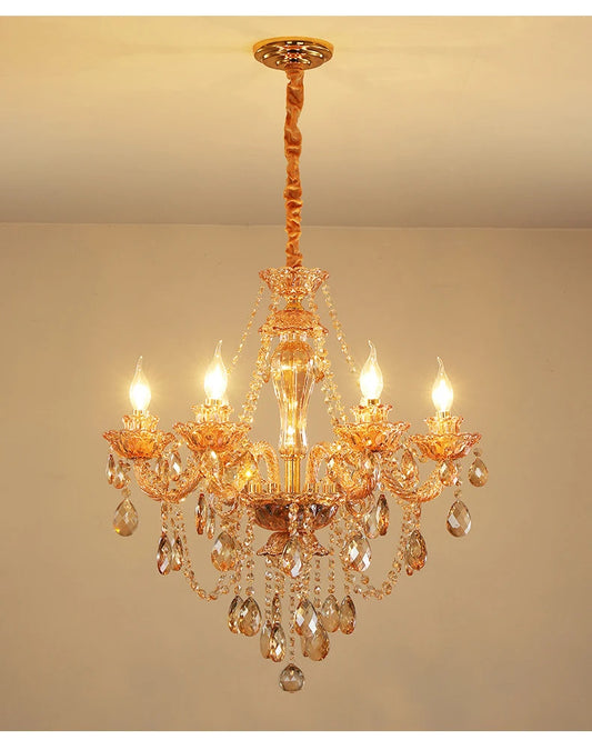Gold crystal chandelier with cascading teardrop and faceted crystal accents, featuring candle-style bulbs and a polished gold finish.