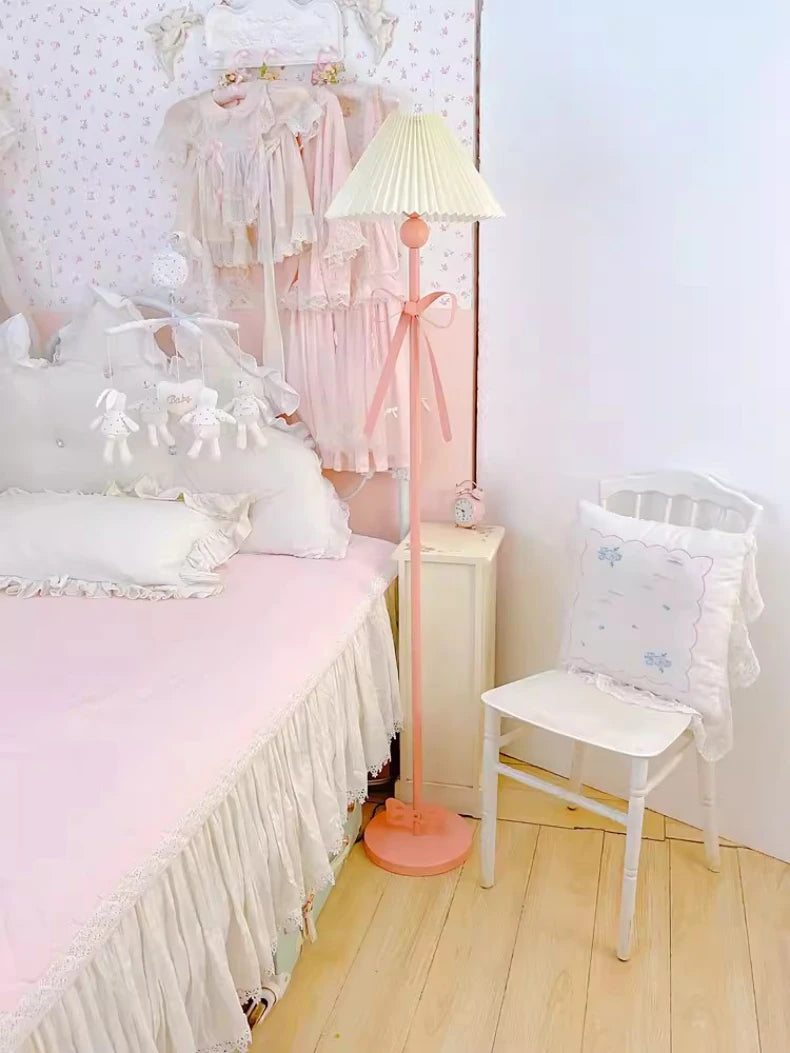 Pastel-colored bedroom with a bed, chair, and lamp.