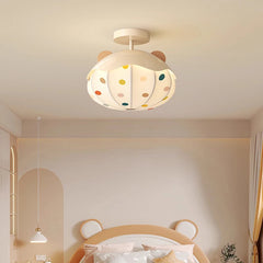 Close-up of a white ceiling light featuring a hot air balloon design with colorful polka dots and wooden accents, attached to a white ceiling.