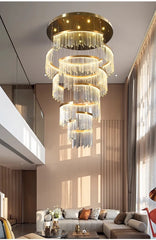 Luxurious chandelier hanging in a modern living room with a sofa and decor.